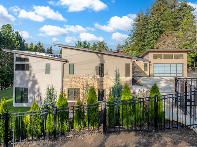 Front of the home behind a black metal fence
