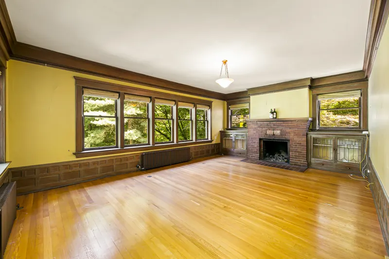 Living room with a fireplace, wood trim and fir floors