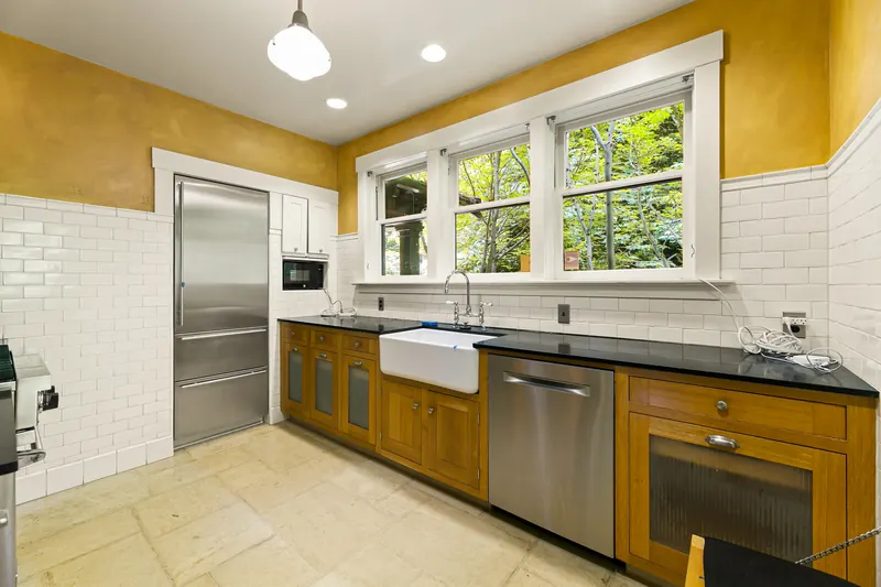 Kitchen with white subway tile and a farmhouse sink