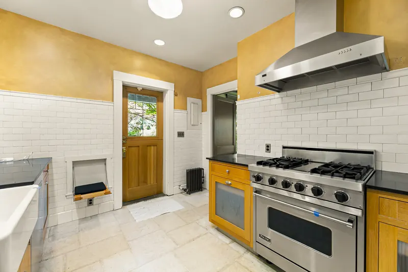 Kitchen with a professional range and wood cabinetry