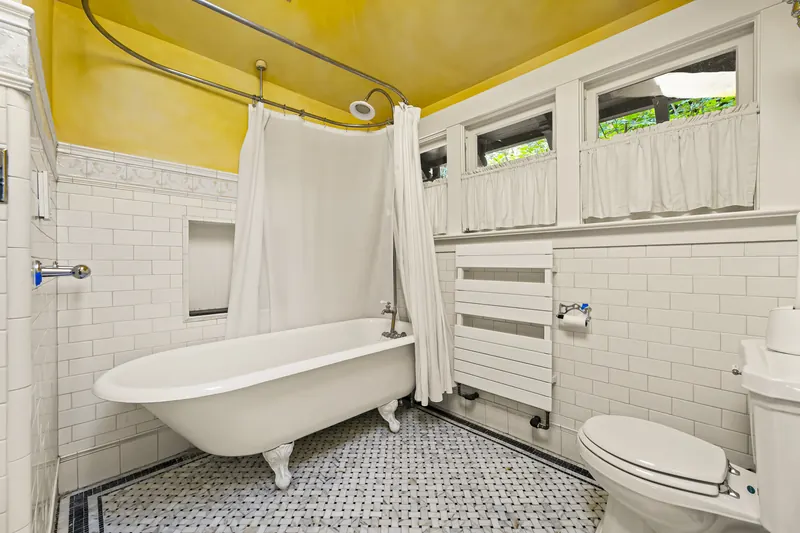Bathroom with a clawfoot tub and subway tile