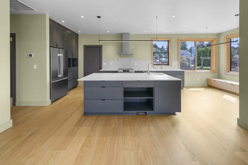 Kitchen and dining area with a large island and oak floors