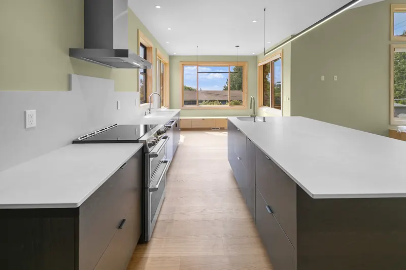 Long view of the kitchen with the range hood and the island