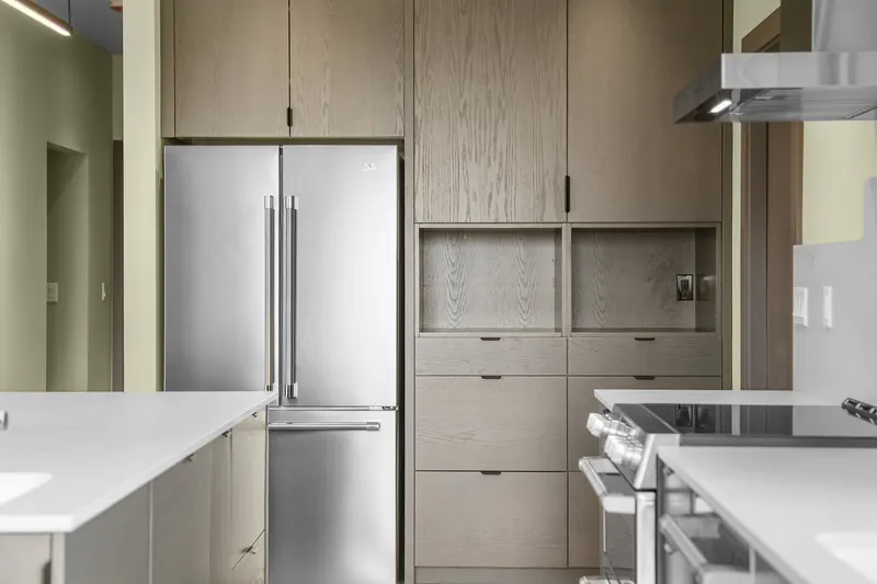Stainless refrigerator and wood built-in cabinetry