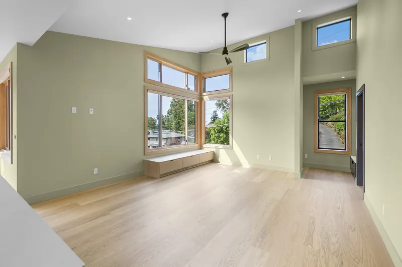 Bright living room with sage walls and oak floors
