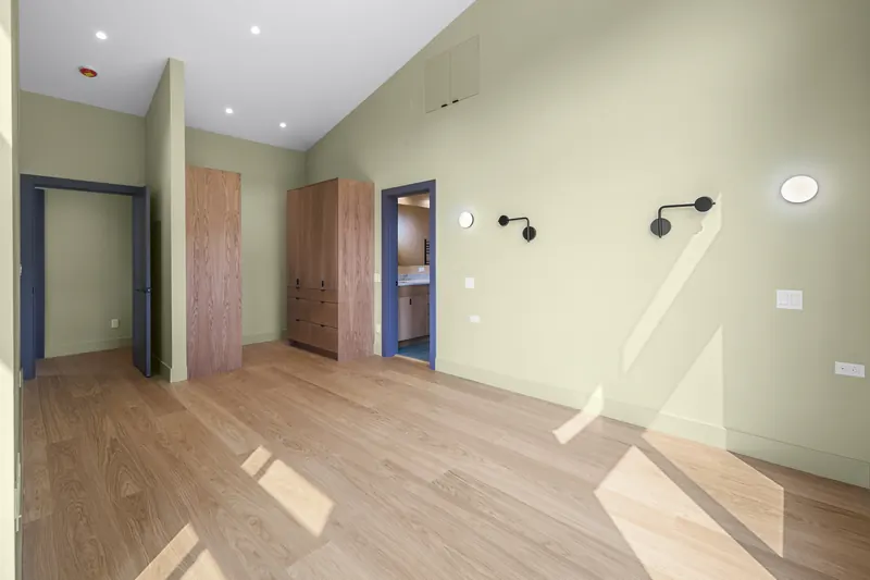 Open room with a vaulted ceiling and oak flooring