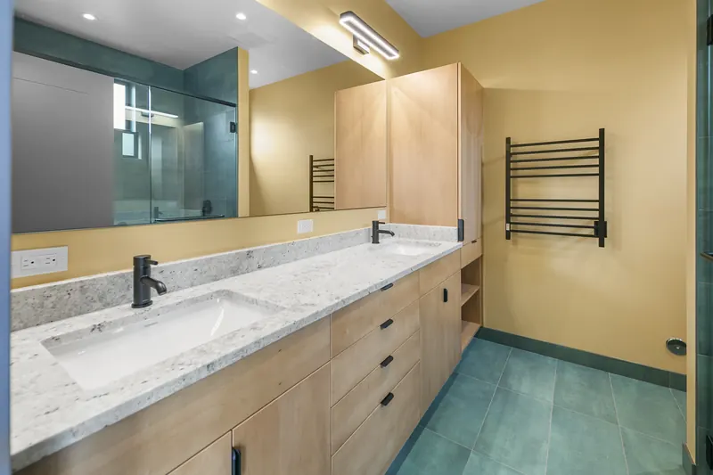 Bathroom vanity with wood cabinets and a stone countertop