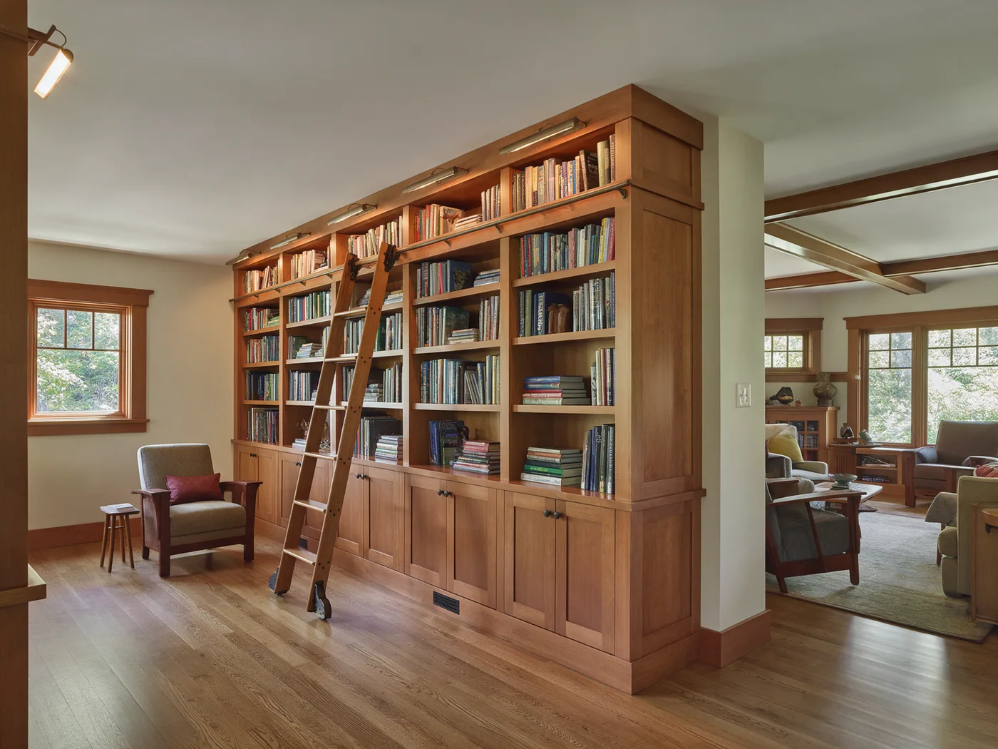 Custom floor-to-ceiling built-in bookshelves with a rolling ladder
