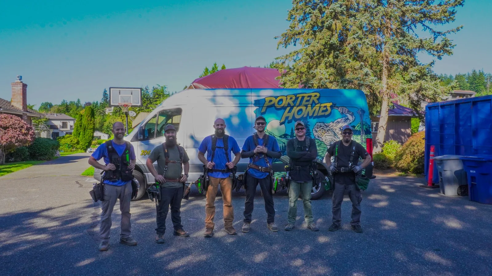 The Porter Homes crew in front of the Porter Homes van with the Bigfoot wrap